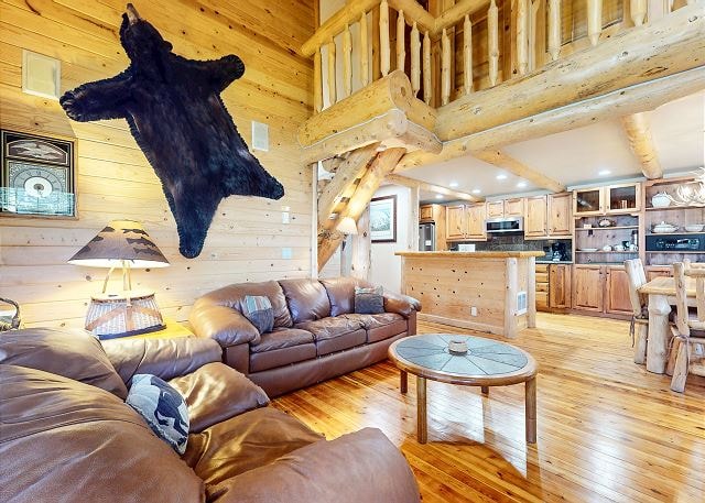 Bedroom with log bed frame and mountain quilt